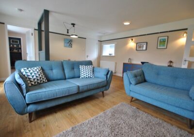 Three seater and two seater sofas. Behind is a dining table.