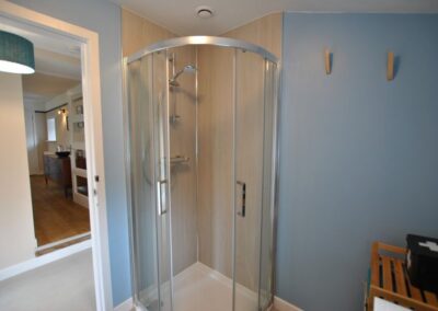 Walk-in shower unit in the corner.