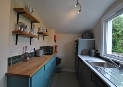 View down kitchen towards fridge unit.