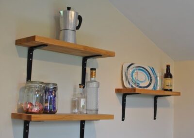 Shelves in the kitchen, laden with goodies.