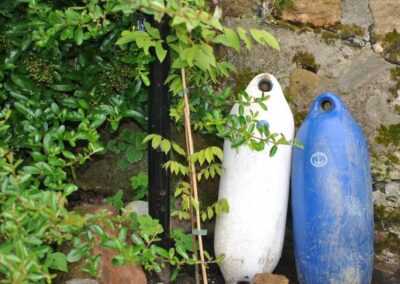 Floats resting against the wall in the garden.