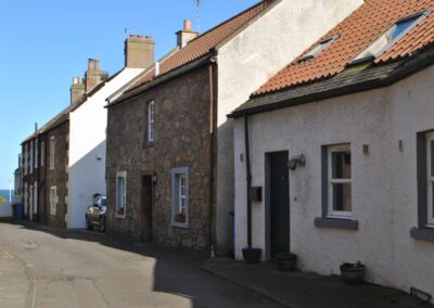 Row of houses with red tiled roofs.