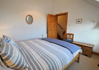 View from headboard towards an open door.