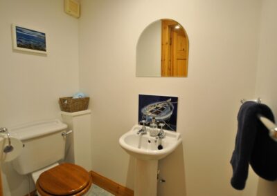 Sink with arched mirror above.