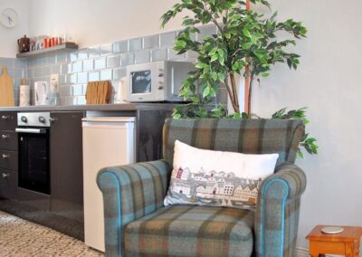 Tartan armchair beside the fridge.