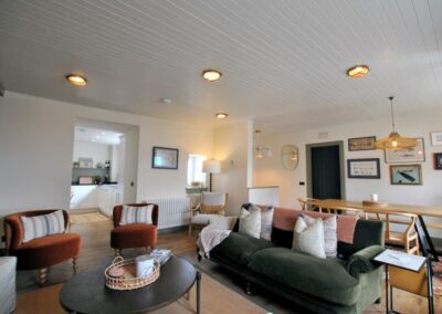 View across lounge and dining area towards open door into kitchen.