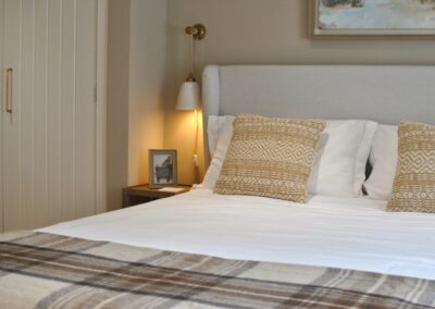 Detail of bedroom cushions in neutral colours.