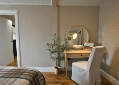 Dressing table with chair and large round mirror.