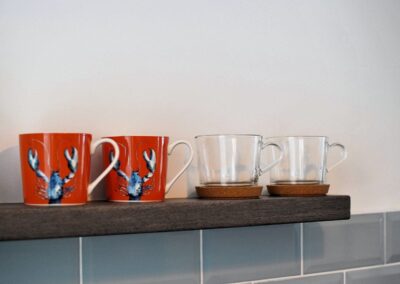 Close-up of two lobster mugs and two transparent cups.