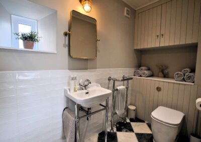 Sink and radiator against a tiled wall.