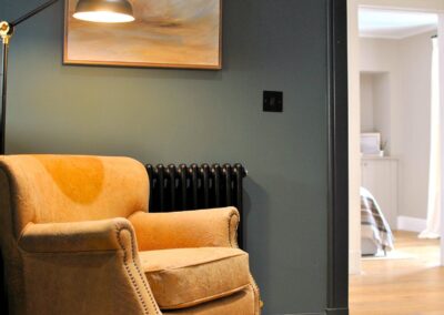 Golden armchair beneath a floor lamp.