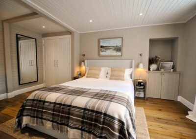 Bedroom in neutral colours with a lot of wood.